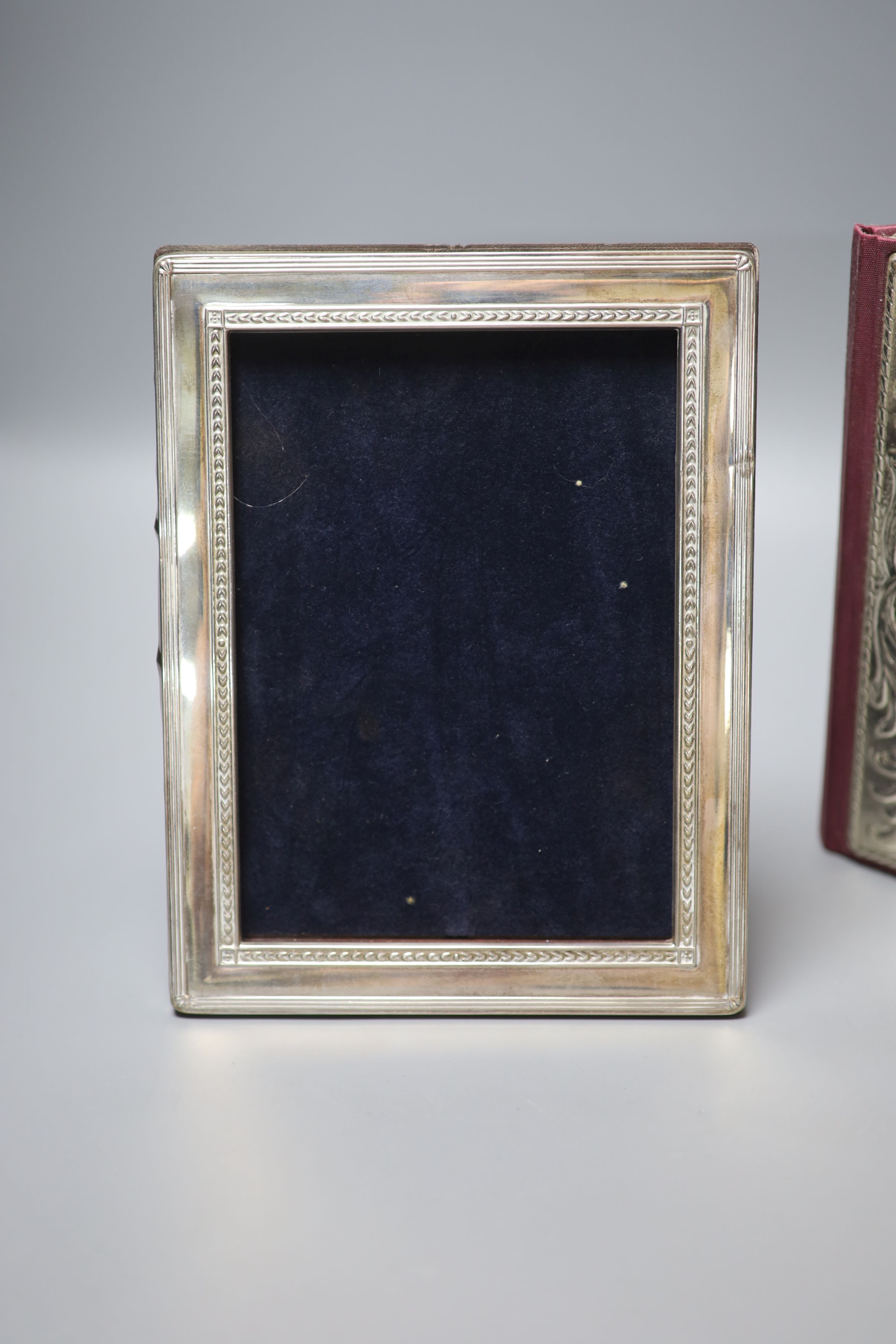 A modern silver mounted photograph frame, 22cm, and a silver mounted address book.